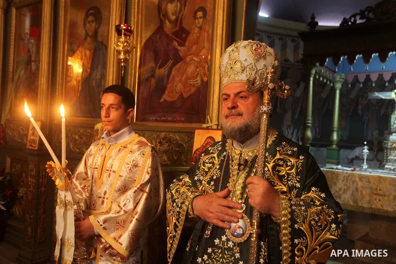 An Orthodox priest leads a Palm Sunday mass at the Saint Porfirios church in Gaza City April 8, 2012. Photo by Ashraf Amra