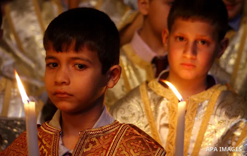 Palestinian Christian Catholics attend an Easter Vigil mass in Gaza City on April 8, 2012. Christians around the world mark the Holy Week of Easter to commemorate the crucifixion and resurrection of Jesus Christ. Photo b...