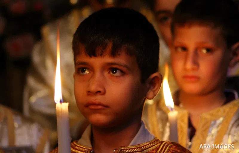 Palestinian Christian Catholics attend an Easter Vigil mass in Gaza City on April 8, 2012. Christians around the world mark the Holy Week of Easter to commemorate the crucifixion and resurrection of Jesus Christ. Photo b...