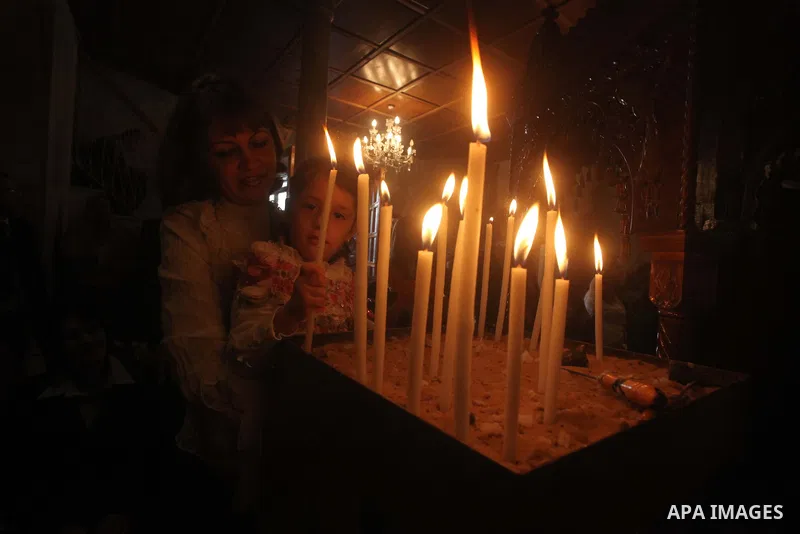Palestinian Christian Catholics attend an Easter Vigil mass in Gaza City on April 8, 2012. Christians around the world mark the Holy Week of Easter to commemorate the crucifixion and resurrection of Jesus Christ. Photo b...