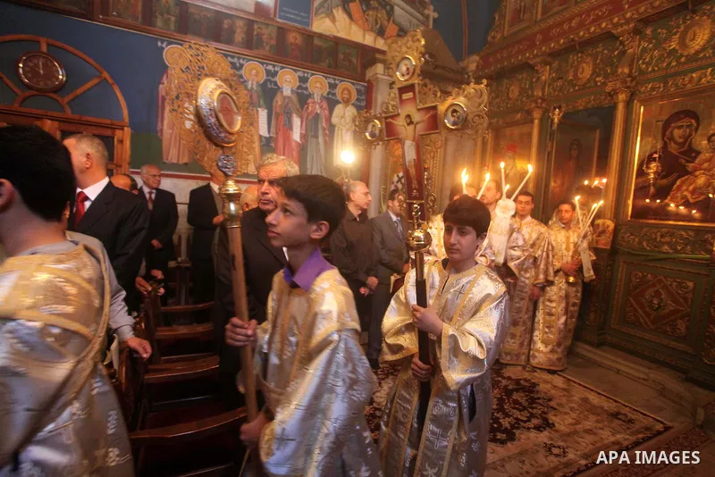 Palestinian Christian Catholics attend an Easter Vigil mass in Gaza City on April 8, 2012. Christians around the world mark the Holy Week of Easter to commemorate the crucifixion and resurrection of Jesus Christ. Photo b...