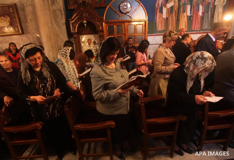 Palestinian Christian Catholics attend an Easter Vigil mass in Gaza City on April 8, 2012. Christians around the world mark the Holy Week of Easter to commemorate the crucifixion and resurrection of Jesus Christ. Photo b...