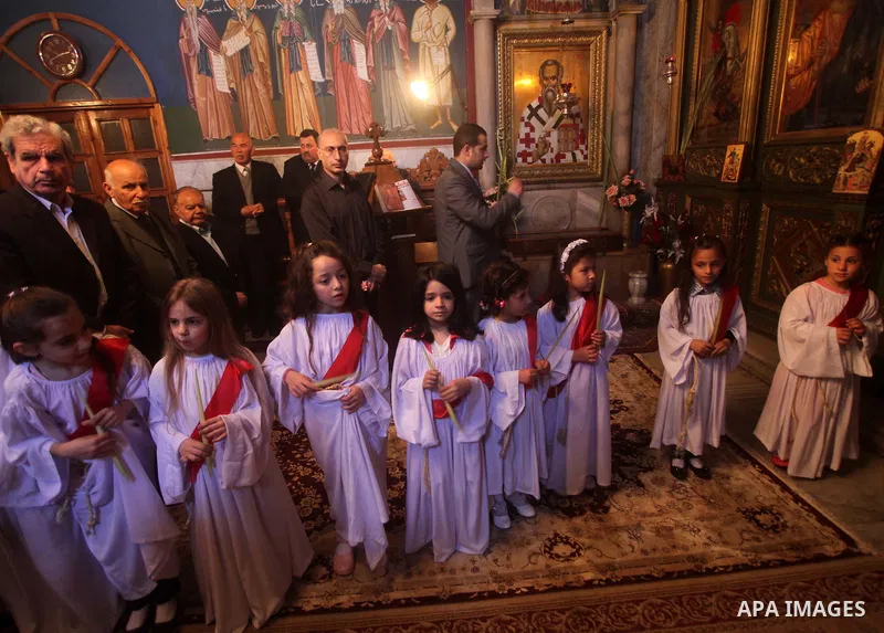 Palestinian Christian Catholics attend an Easter Vigil mass in Gaza City on April 8, 2012. Christians around the world mark the Holy Week of Easter to commemorate the crucifixion and resurrection of Jesus Christ. Photo b...