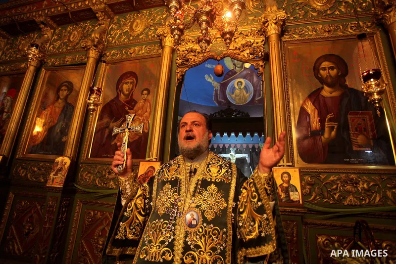 An Orthodox priest leads a Palm Sunday mass at the Saint Porfirios church in Gaza City April 8, 2012. Photo by Ashraf Amra