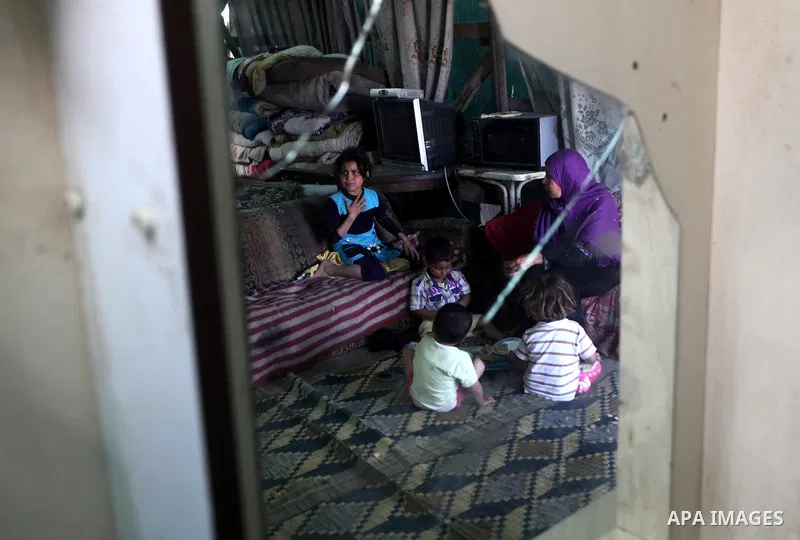 A Palestinian family eating inside his family house in a poor region of the Al-Nusirat neighborhood, central Gaza Strip on 08 April 2012. Reports from the World Bank on 06 April 2012 state that The World Banks Board of...