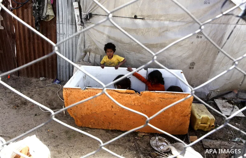 Palestinian girls sit outside her family house in a poor region of the Al-Nusirat neighborhood, central Gaza Strip on 08 April 2012. Reports from the World Bank on 06 April 2012 state that The World Banks Board of Direc...
