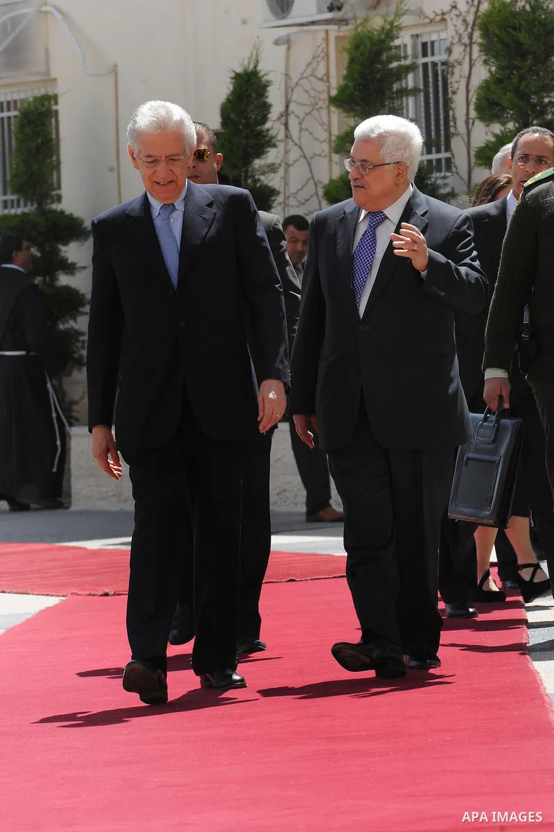 Palestinian President Mahmoud Abbas, meets with Italy's Prime Minister Mario Monti past an honour guard during a welcoming ceremony in the West Bank city of Ramallah April 8, 2012. Photo by Thaer Ganaim