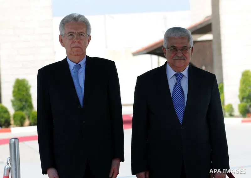 Palestinian President Mahmoud Abbas, meets with Italy's Prime Minister Mario Monti past an honour guard during a welcoming ceremony in the West Bank city of Ramallah April 8, 2012. Photo by Thaer Ganaim
