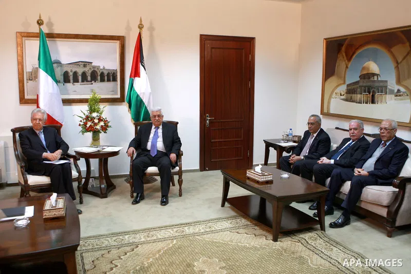 Palestinian President Mahmoud Abbas, meets with Italy's Prime Minister Mario Monti past an honour guard during a welcoming ceremony in the West Bank city of Ramallah April 8, 2012. Photo by Thaer Ganaim
