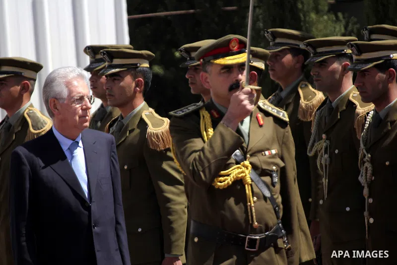Palestinian President Mahmoud Abbas gestures meets with Italy's Prime Minister Mario Monti past an honour guard during a welcoming ceremony in the West Bank city of Ramallah April 8, 2012. Photo by Issam Rimawi