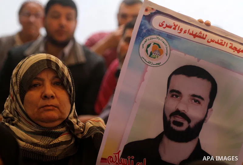Palestinians hold pictures of their prisoned relatives in Israeli jails as they gather in a weekly activity calling for their liberty at the Red Cross headquarters in Gaza City on Apr. 09, 2012. Photo by Mohammed Asad