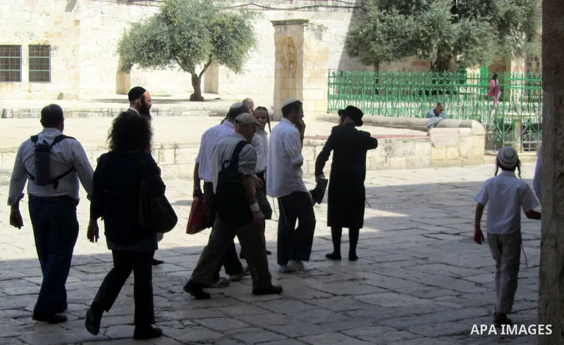 Jewish settlers stand in the yards of Al Aqsa Mosque in the old city of Jerusalem on Apr. 08, 2012. Photo by Mahfouz Abu Turk