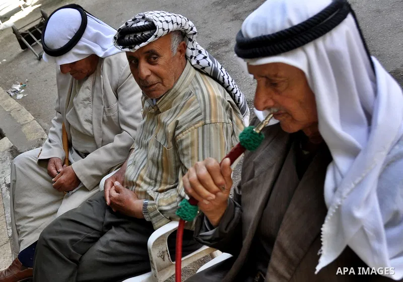 Palestinian elderly smoking waterpipes at cafe in the West Bank city of Nablus, on April, 10, 2012. Photo by Nedal Eshtayah