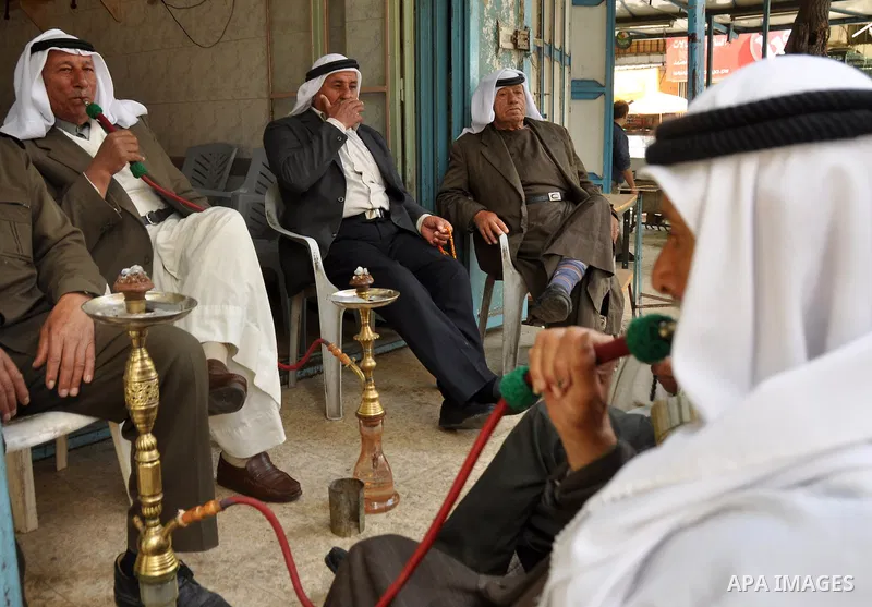 Palestinian elderly smoking waterpipes at cafe in the West Bank city of Nablus, on April, 10, 2012. Photo by Nedal Eshtayah