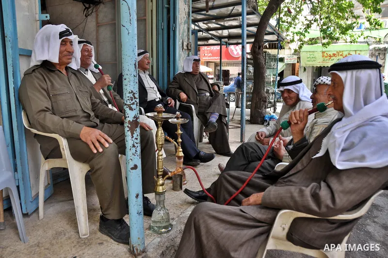 Palestinian elderly smoking waterpipes at cafe in the West Bank city of Nablus, on April, 10, 2012. Photo by Nedal Eshtayah