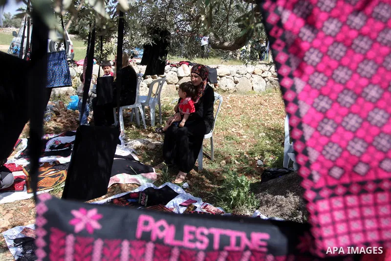 Palestinian Prime Minister Salam Fayyad, (not seen) participates in the Sixth International Conference of the Bil'in popular resistance, in the village of Bil'in, in the West Bank city of Ramallah April 10, 2012. Photo b...