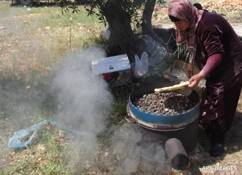 Palestinian Prime Minister Salam Fayyad, (not seen) participates in the Sixth International Conference of the Bil'in popular resistance, in the village of Bil'in, in the West Bank city of Ramallah April 10, 2012. Photo b...