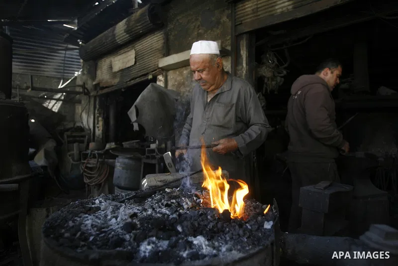 A Palestinian man works at a metal workshop in Rafah, southern Gaza Strip on April 10, 2012. Gaza has been in the grip of a severe power crisis for months now, with its sole electricity plant unable to function because o...