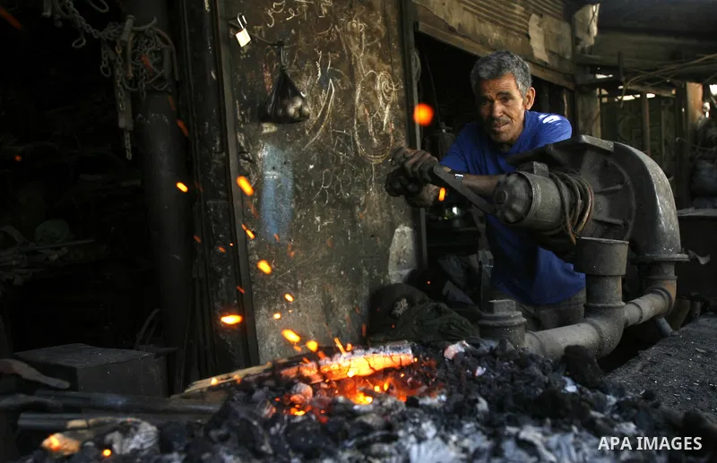 A Palestinian man works at a metal workshop in Rafah, southern Gaza Strip on April 10, 2012. Gaza has been in the grip of a severe power crisis for months now, with its sole electricity plant unable to function because o...