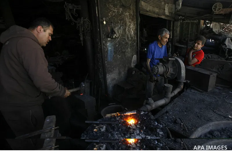 A Palestinian man works at a metal workshop in Rafah, southern Gaza Strip on April 10, 2012. Gaza has been in the grip of a severe power crisis for months now, with its sole electricity plant unable to function because o...
