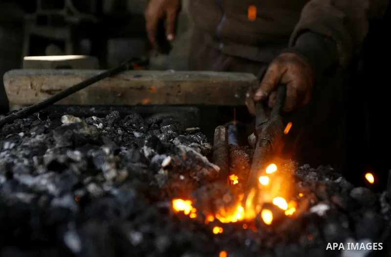 A Palestinian man works at a metal workshop in Rafah, southern Gaza Strip on April 10, 2012. Gaza has been in the grip of a severe power crisis for months now, with its sole electricity plant unable to function because o...