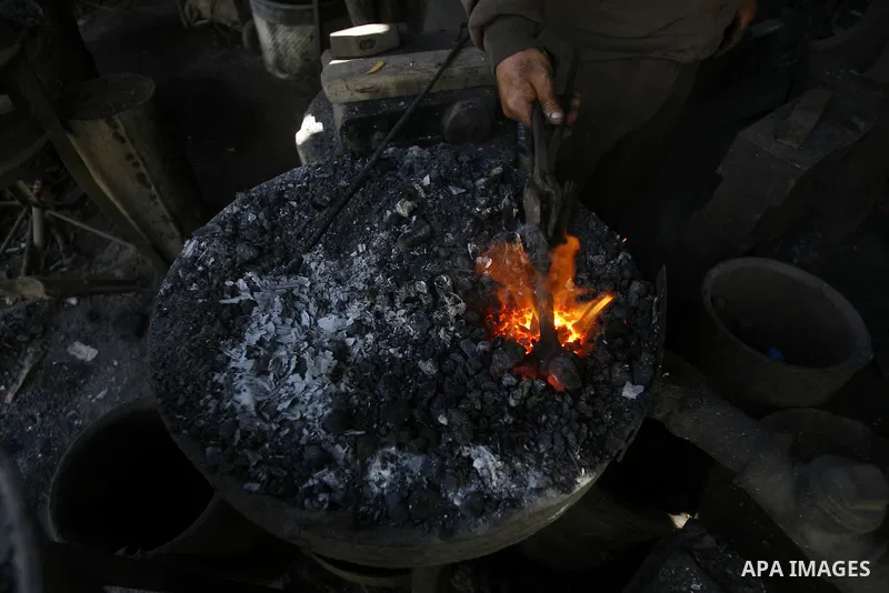 A Palestinian man works at a metal workshop in Rafah, southern Gaza Strip on April 10, 2012. Gaza has been in the grip of a severe power crisis for months now, with its sole electricity plant unable to function because o...