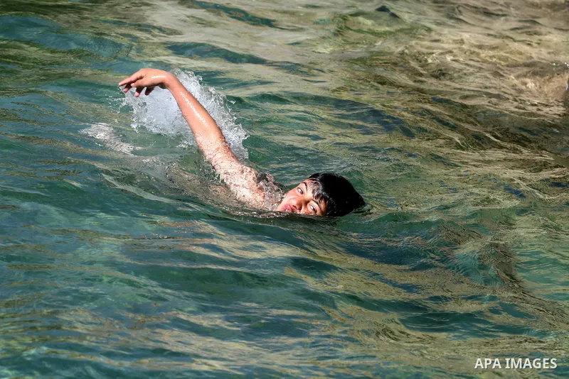 Palestinian boy jumps in the pool spring water "Jriot" near Ramallah in the West Bank, April 10, 2012. Photo by Issam Rimawi