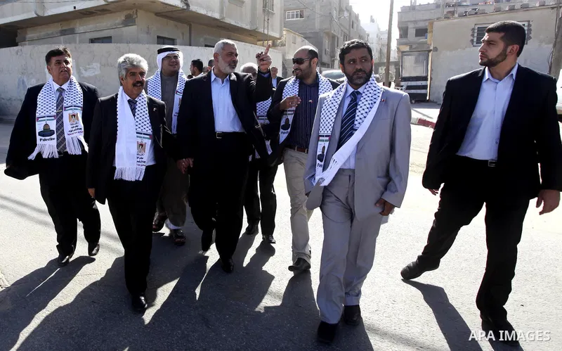 Palestinian Prime Minister in Gaza Strip, Ismail Haniya speaks with the Head of the Bahrani delegation during their tour to al-Shatea refugee camp in Gaza city on April 11,2012. The Bahrani delegation is in an official v...