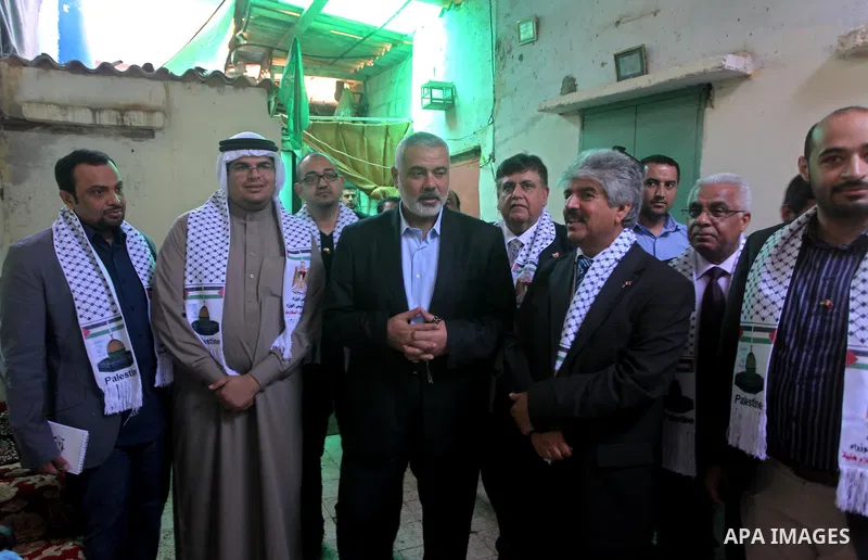 Palestinian Prime Minister in Gaza Strip, Ismail Haniya speaks with the Head of the Bahrani delegation during their tour to al-Shatea refugee camp in Gaza city on April 11,2012. The Bahrani delegation is in an official v...