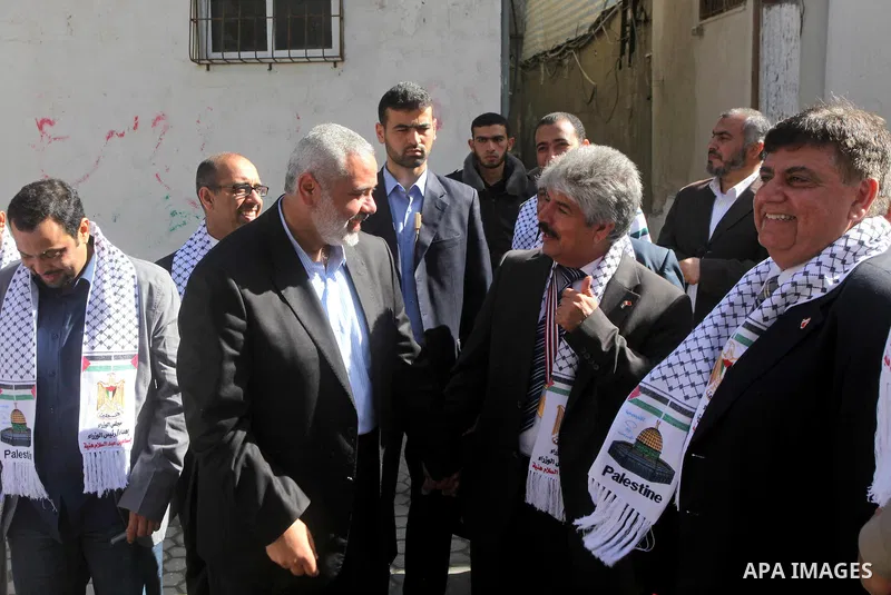 Palestinian Prime Minister in Gaza Strip, Ismail Haniya speaks with the Head of the Bahrani delegation during their tour to al-Shatea refugee camp in Gaza city on April 11,2012. The Bahrani delegation is in an official v...