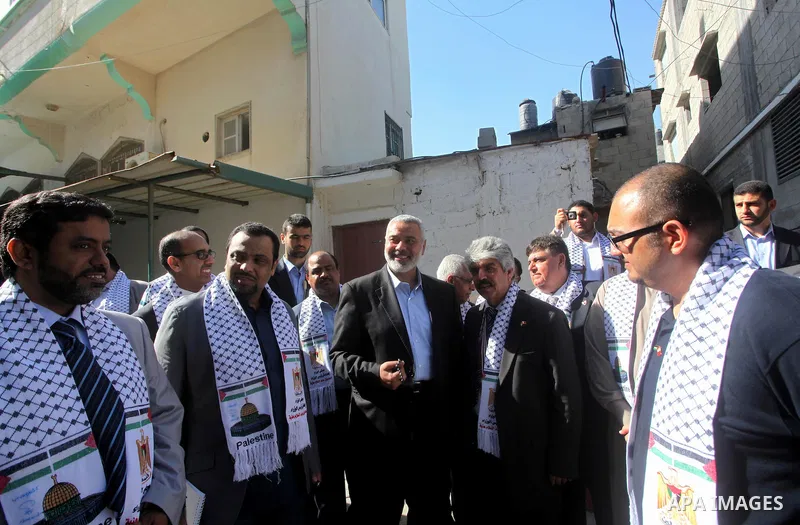 Palestinian Prime Minister in Gaza Strip, Ismail Haniya speaks with the Head of the Bahrani delegation during their tour to al-Shatea refugee camp in Gaza city on April 11,2012. The Bahrani delegation is in an official v...