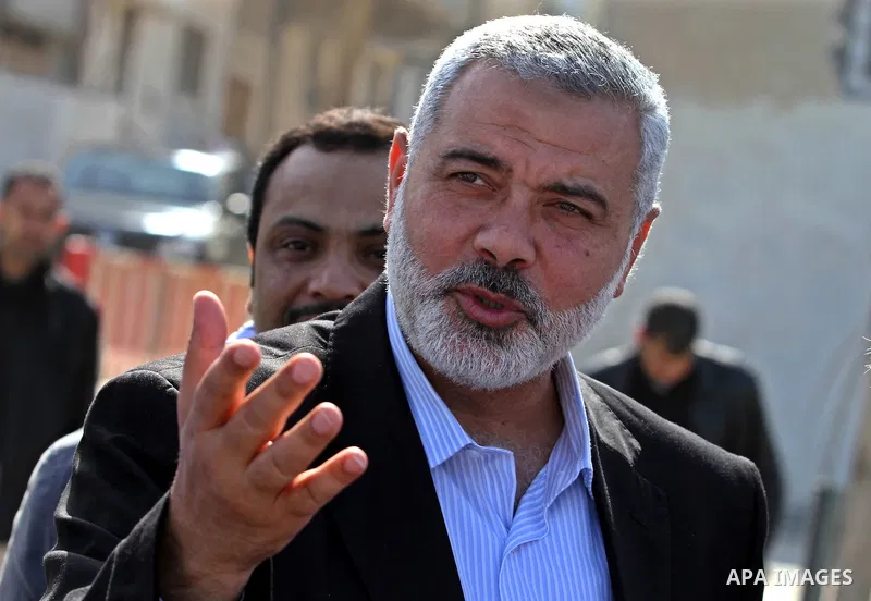 Palestinian Prime Minister in Gaza Strip, Ismail Haniya speaks with the Head of the Bahrani delegation during their tour to al-Shatea refugee camp in Gaza city on April 11,2012. The Bahrani delegation is in an official v...