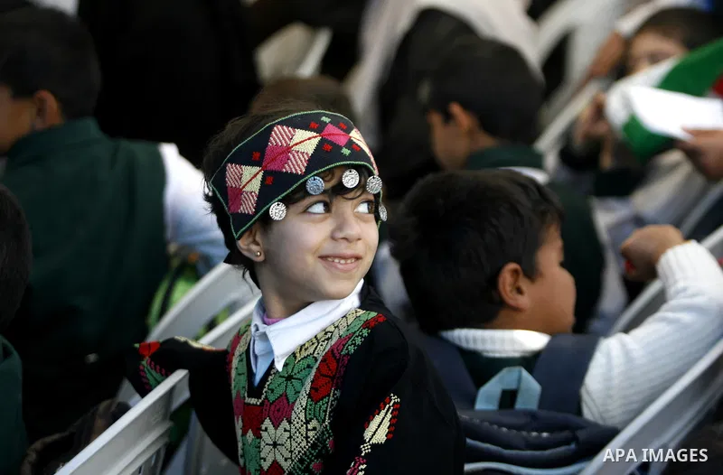 Palestinians take part in the exhibition for the palestinian heritage organized by Dar al-Fadela school in the southern Gaza Strip town of Rafah on April 11, 2012. The exhibition displays the Palestinian heritage works f...