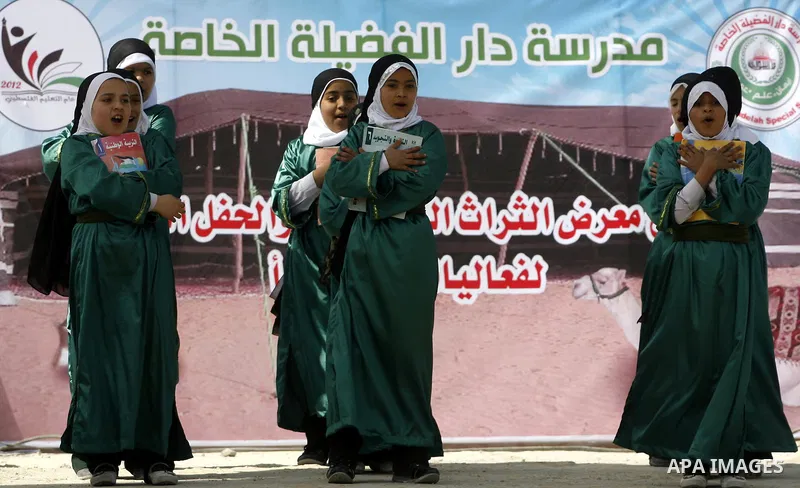Palestinians take part in the exhibition for the palestinian heritage organized by Dar al-Fadela school in the southern Gaza Strip town of Rafah on April 11, 2012. The exhibition displays the Palestinian heritage works f...
