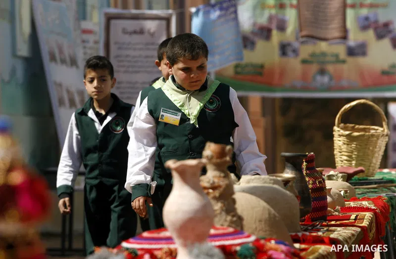 Palestinians take part in the exhibition for the palestinian heritage organized by Dar al-Fadela school in the southern Gaza Strip town of Rafah on April 11, 2012. The exhibition displays the Palestinian heritage works f...