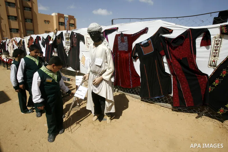 Palestinians take part in the exhibition for the palestinian heritage organized by Dar al-Fadela school in the southern Gaza Strip town of Rafah on April 11, 2012. The exhibition displays the Palestinian heritage works f...