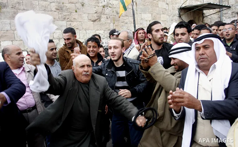 Palestinian celebrates during the wedding of the Palestinian bride and groom Maha Salam (unseen) and Thayer Qasem (unseen) in Deir Istia village the West Bank city of Nablus, on April 12, 2012. The newlyweds traveled fro...