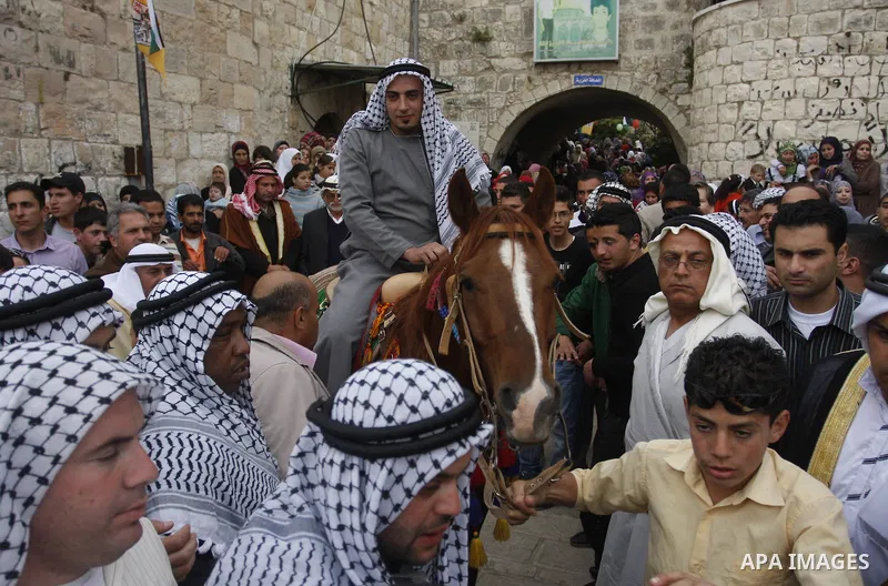 Palestinian celebrates during the wedding of the Palestinian bride and groom Maha Salam (unseen) and Thayer Qasem (unseen) in Deir Istia village the West Bank city of Nablus, on April 12, 2012. The newlyweds traveled fro...