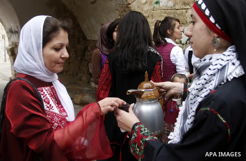 Women celebrates during the wedding of the Palestinian bride and groom Maha Salam (unseen) and Thayer Qasem (unseen) in Deir Istia village the West Bank city of Nablus, on April 12, 2012. The newlyweds traveled from the...