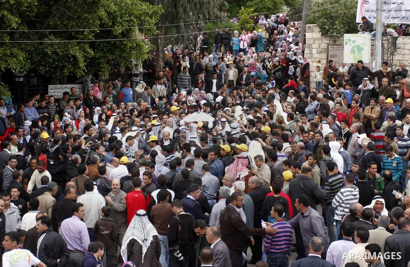 Palestinian celebrates during the wedding of the Palestinian bride and groom Maha Salam (unseen) and Thayer Qasem (unseen) in Deir Istia village the West Bank city of Nablus, on April 12, 2012. The newlyweds traveled fro...