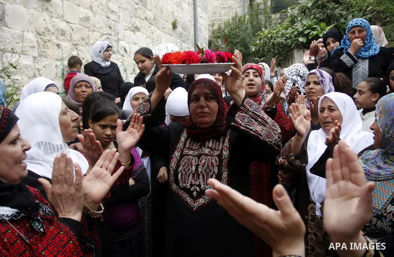 Women celebrates during the wedding of the Palestinian bride and groom Maha Salam (unseen) and Thayer Qasem (unseen) in Deir Istia village the West Bank city of Nablus, on April 12, 2012. The newlyweds traveled from the...