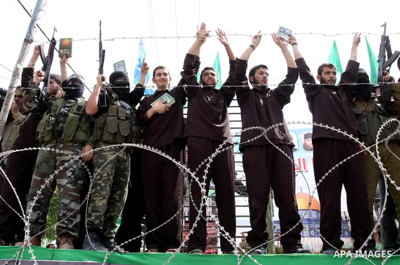 Hamas supporters acting as freed prisoners take part in a rally, calling for the release of Palestinian prisoners from Israeli jails, in Jabalya, in the northern Gaza Strip, April 13, 2012. Photo by Mohammed Asad