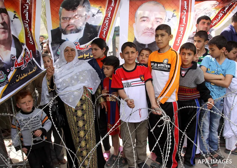Palestinian boys attend a rally, calling for the release of Palestinian prisoners from Israeli jails, in Jabalya, in the northern Gaza Strip, April 13, 2012. Photo by Mohammed Asad