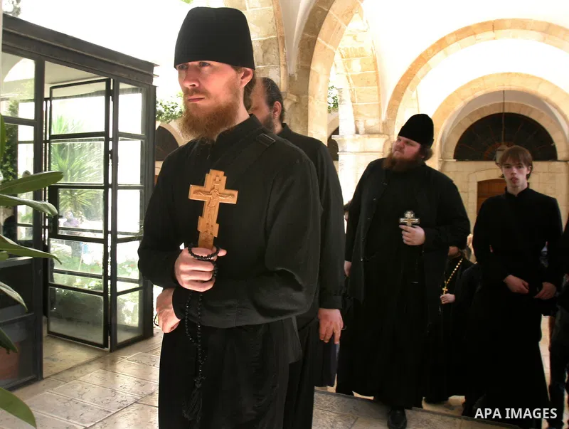 A Christian worshipper holds a cross in the Church of the Holy Sepulchre during the Eastern and Orthodox Church's Good Friday procession in the Old City of Jerusalem April 13, 2012. Photo by Mahfouz Abu Turk