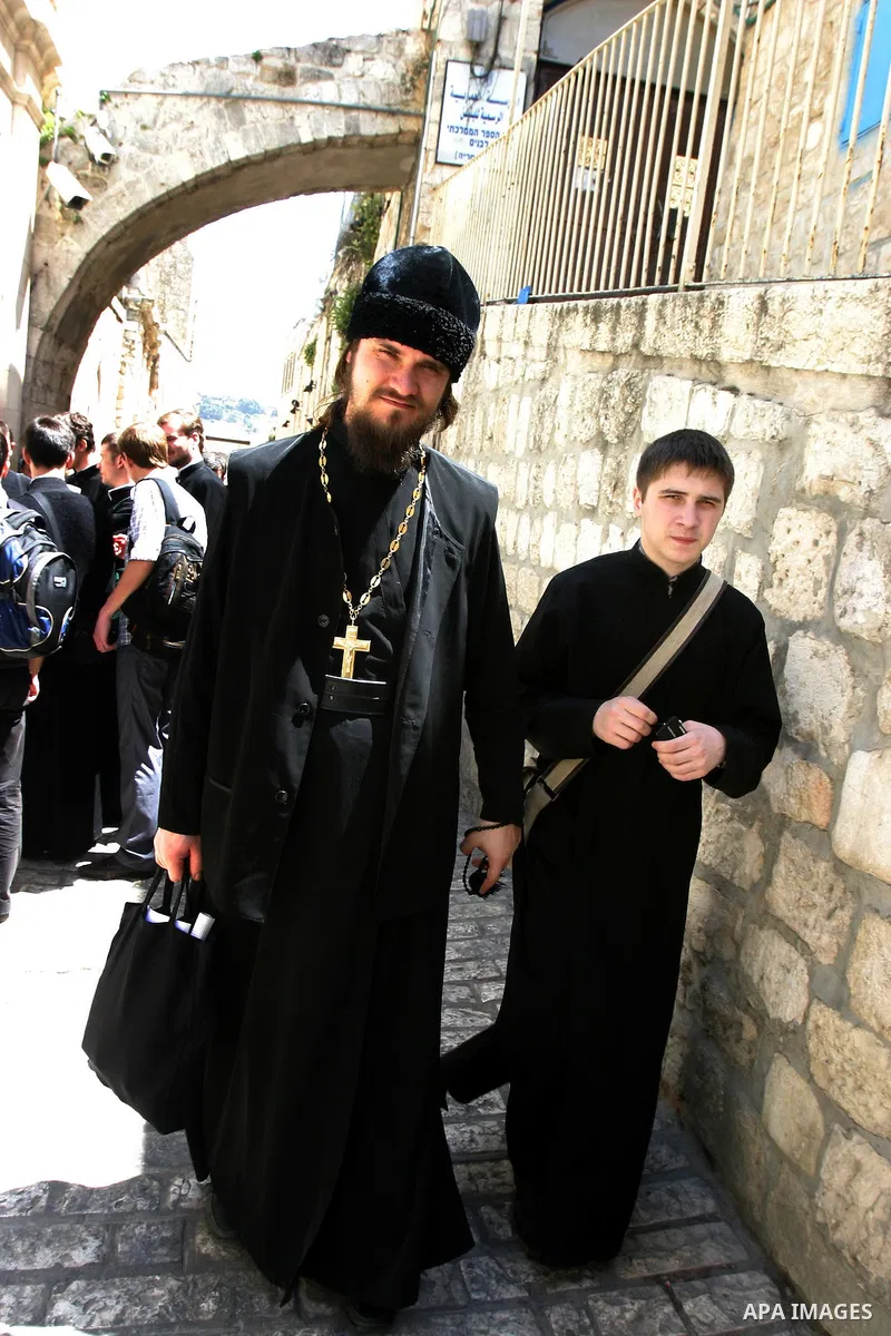 Russian Orthodox priests and pilgrims stop at the Fifth Station of the Cross along the Via Dolorosa on Good Friday in the Old City of Jerusalem. -- Eastern Orthodox Christians of many traditions converged on the Old City...
