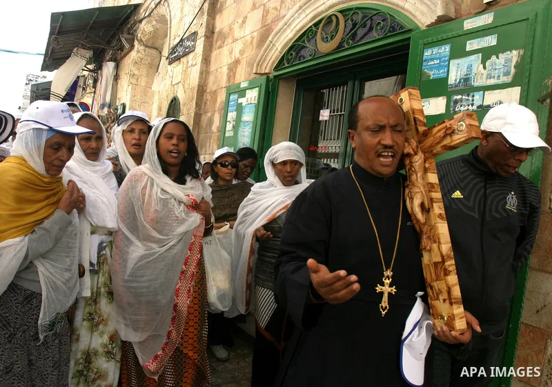 Orthodox Christian worshippers from Ethiopia carry a large cross during a Good Friday procession on the Via Dolorosa, retracing the route Jesus Christ walked to his crucifixion in Jerusalem, Israel, 13 April 2012. Thousa...