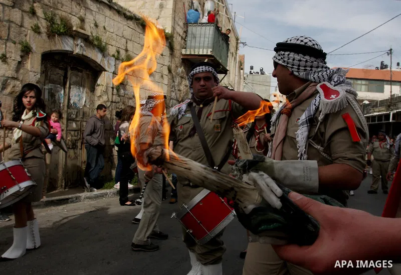 Palestinian Christians take part in the "Holy Fire" procession on the eve of Orthodox Easter in the West Bank city of Ramallah on April 14, 2012. The date of Orthodox Easter is calculated differently than by the Roman Ca...