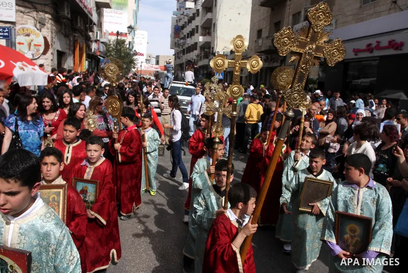 Palestinian Christians take part in the "Holy Fire" procession on the eve of Orthodox Easter in the West Bank city of Ramallah on April 14, 2012. The date of Orthodox Easter is calculated differently than by the Roman Ca...