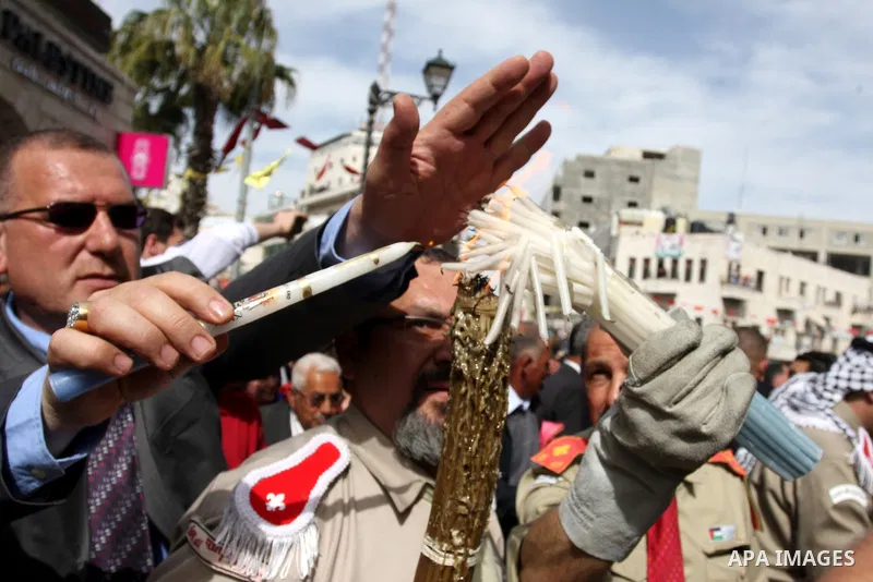 Palestinian Christians take part in the "Holy Fire" procession on the eve of Orthodox Easter in the West Bank city of Ramallah on April 14, 2012. The date of Orthodox Easter is calculated differently than by the Roman Ca...