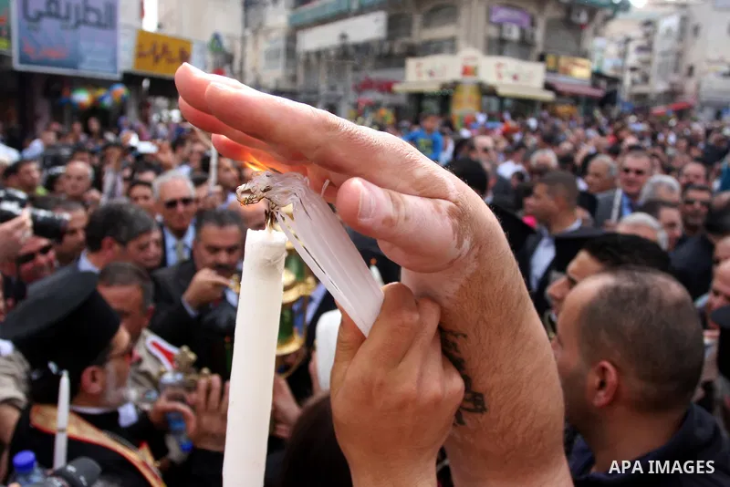 Palestinian Christians take part in the "Holy Fire" procession on the eve of Orthodox Easter in the West Bank city of Ramallah on April 14, 2012. The date of Orthodox Easter is calculated differently than by the Roman Ca...